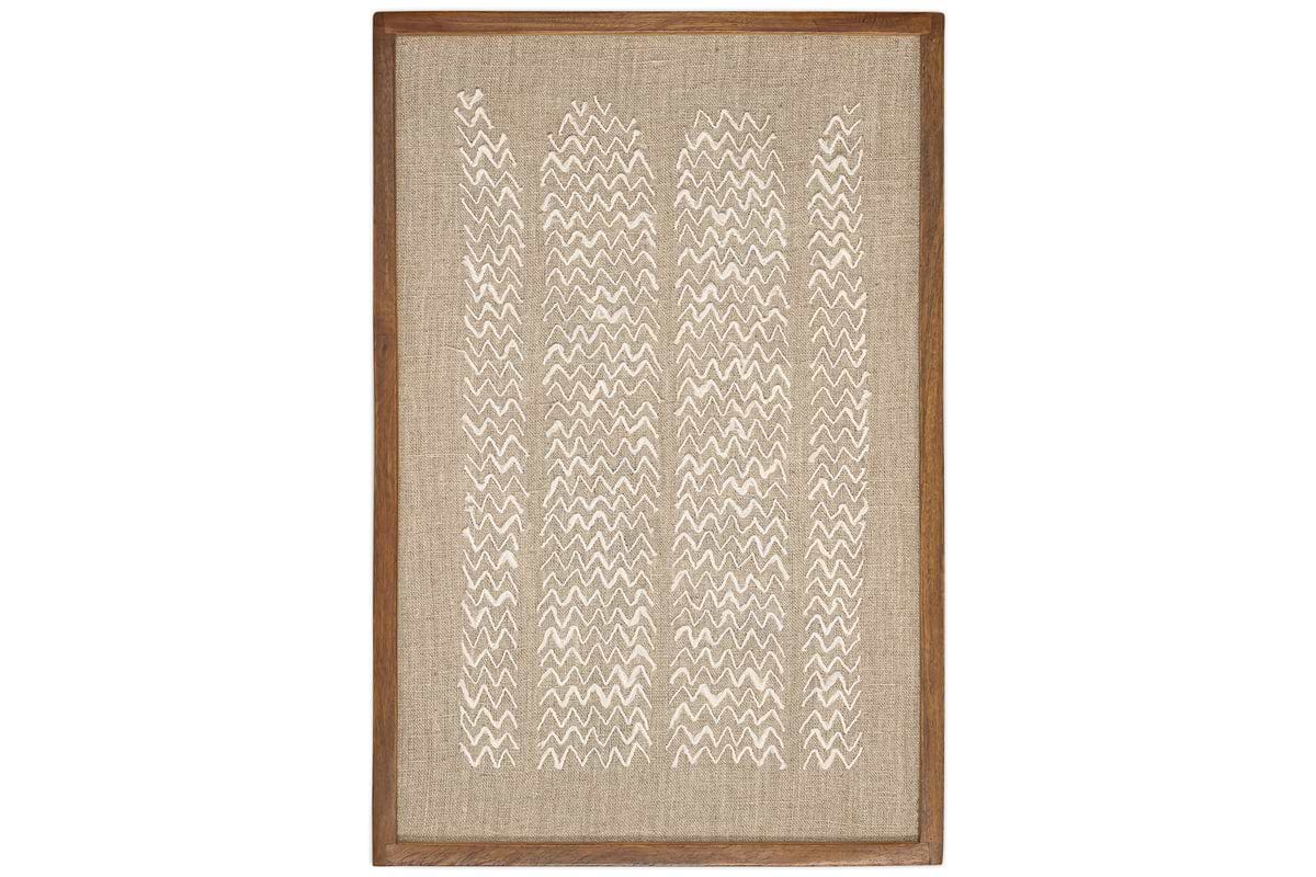 The Samaya Hand Stitched Wall Art by nkuku features a rectangular, sustainable mango wood frame, a tan linen background, and vertical rows of white zigzag stitching for a modern geometric look.