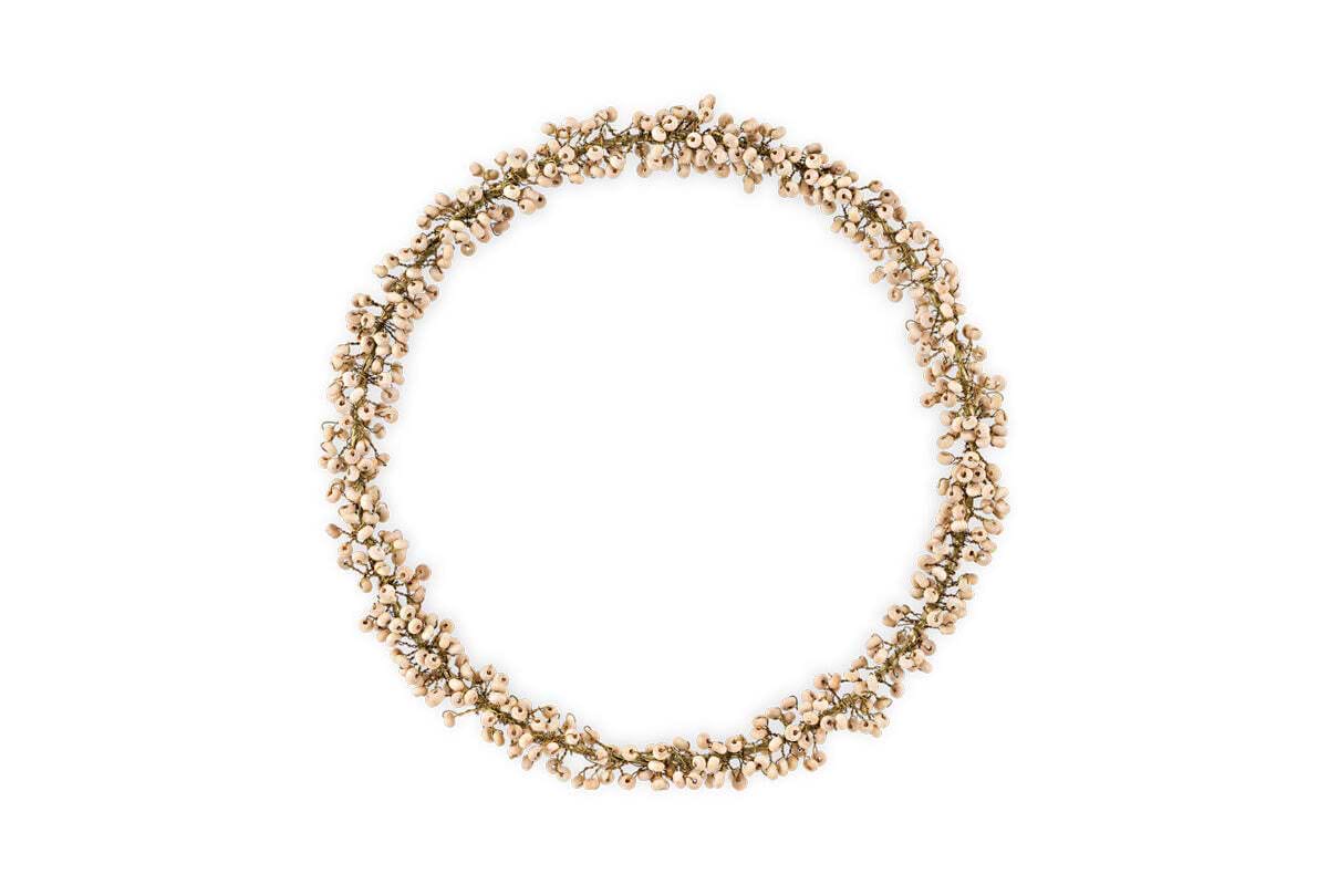The nkuku Tanu Mango Wood Beaded Wreath in Brass & Natural features small, light-colored beads and antique brass wire in a clustered, circular design with a natural, textured look against a plain white background.