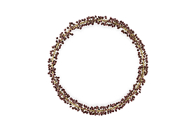 The Tanu Mango Wood Beaded Wreath by nkuku features brass and ruby beads arranged in a circular, organic pattern, creating a festive, textured look against a plain white background.