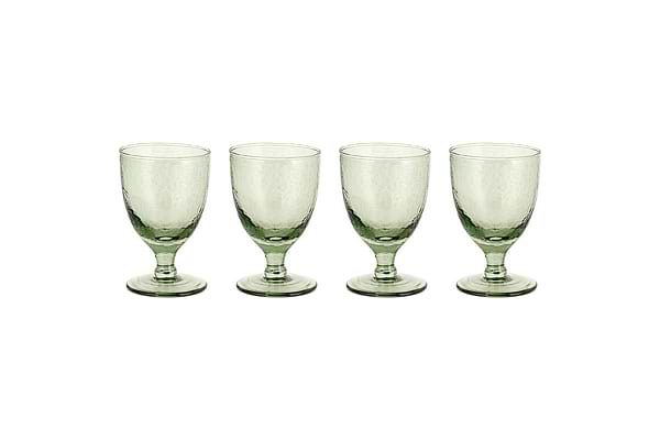 Four sage green Yala Hammered Wine Glasses by nkuku are arranged in a row on a white background. Set of 4.