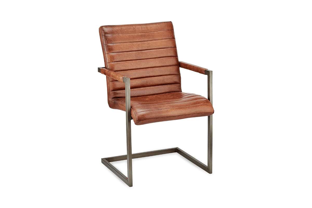 The Wamma Leather Desk Chair by nkuku features dark chocolate brown leather with a ribbed design, slim metal armrests, and a cantilevered rectangular frame for an industrial-vintage look that pops against a white background.