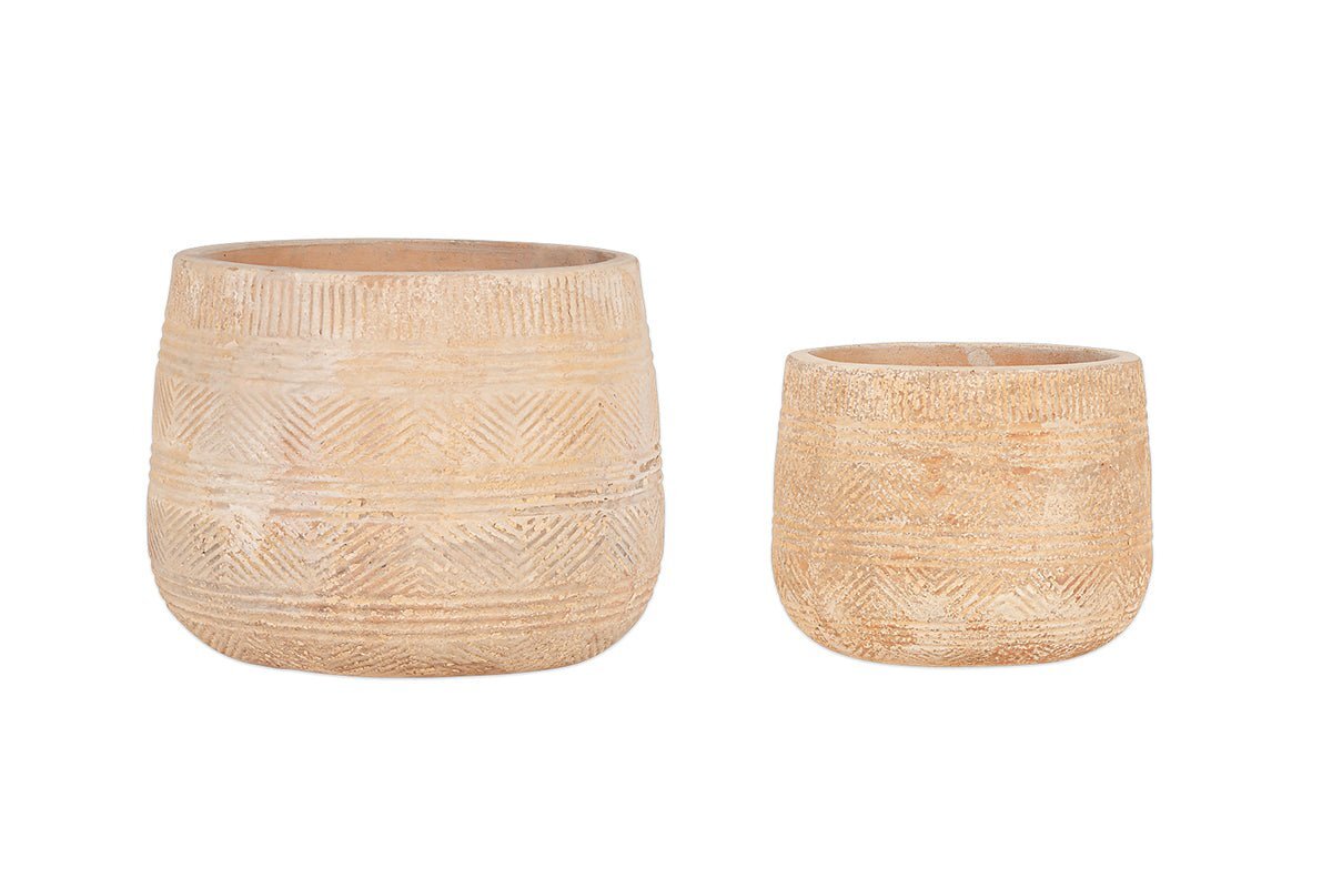 The Zadie Etched Ceramic Planters by nkuku (Set of 2) feature light tan, cylindrical designs with carved geometric patterns; the larger planter sits beside the smaller one against a white background.