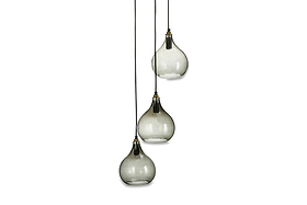 The nkuku Ziva Recycled Glass Cluster Pendant in Green Smoke features three adjustable modern glass lights with smoky teardrop shades and brass accents, hanging at different heights for a chic, contemporary look.