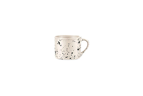 The nkuku Ama Short Splatter Mug (Set of 2) features a handmade white ceramic design with a curved handle and irregular black splatter pattern, shown centered on a plain white background for a minimalist, modern look.