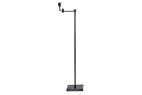 The Kara Iron Floor Lamp by nkuku features a slim, straight bronze iron pole on a square base with an angled arm and exposed bulb socket, offering a minimalist, modern design without a lampshade for simple functionality.