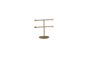 The Liman Jewellery Stand by nkuku features a minimalist brass finish with two horizontal bars on a central rod and a round base, perfect for organizing and displaying necklaces or bracelets in modern style.