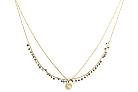 The nkuku Mai Necklace is a delicate layered gold piece with two thin chains—one featuring small pyrite stones and the other holding a round textured gold pendant.