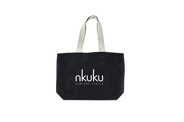 A black Jute & Cotton Tote Bag by nkuku with beige handles is centered on a white background. Large white "nkuku" text and smaller "HOME AND LIFESTYLE" appear on the bag.