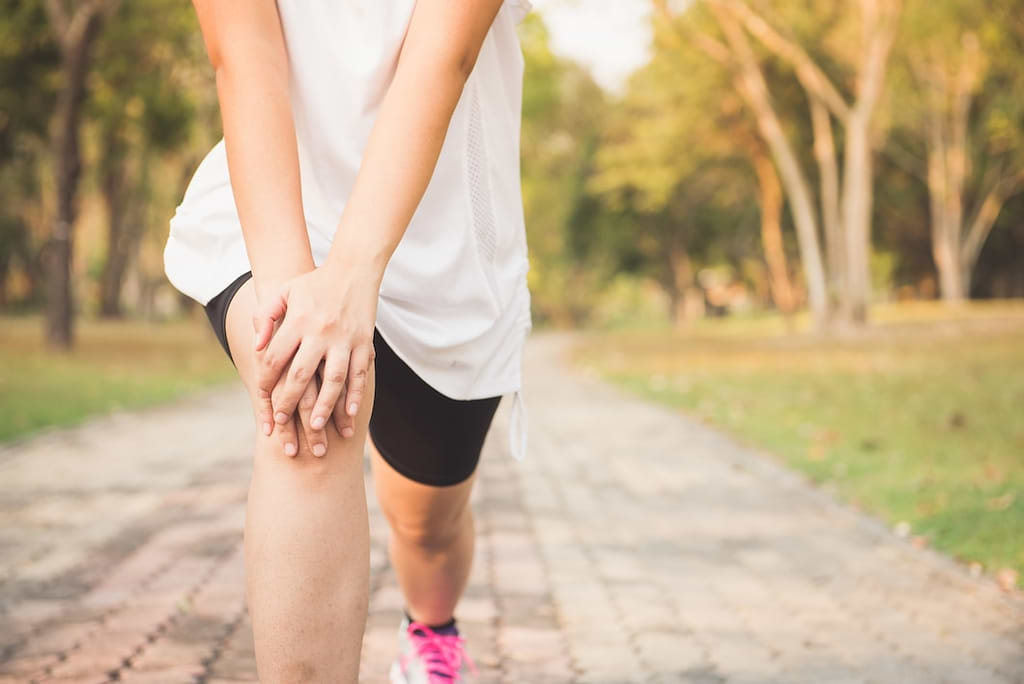 woman stretching her knees