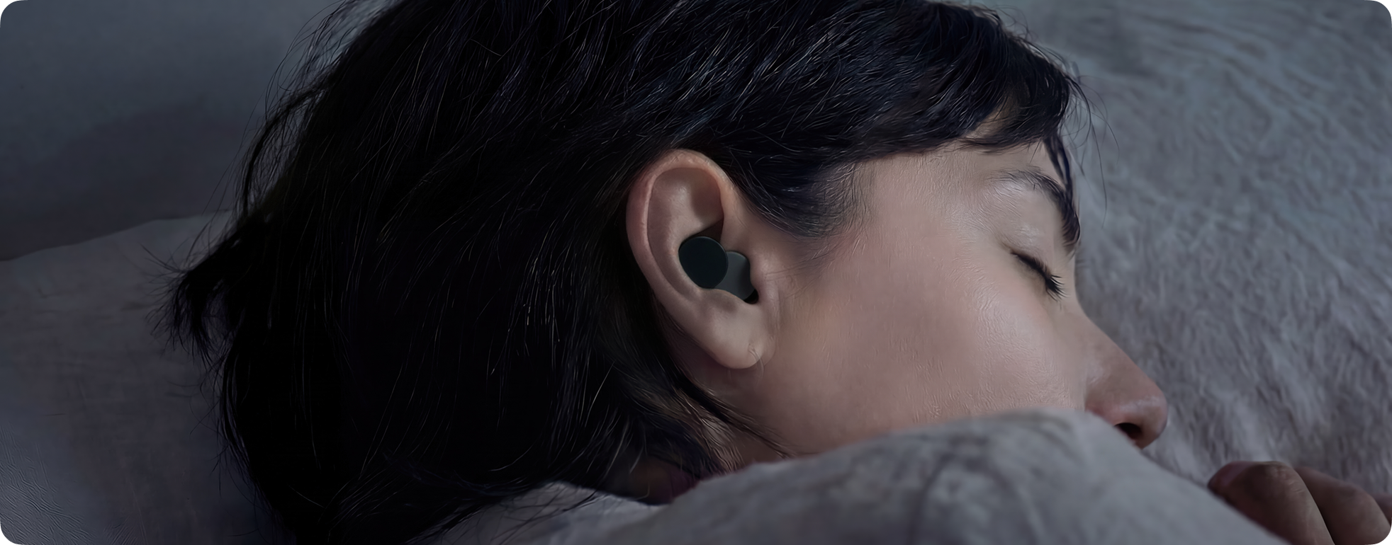 Side sleeper sleeping peacefully with silicone Orbit Earplugs.