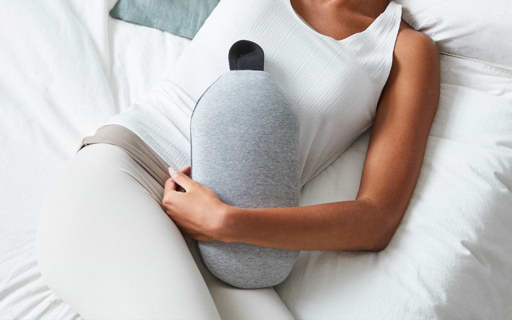 Woman using Ostrichpillow's Heatbag