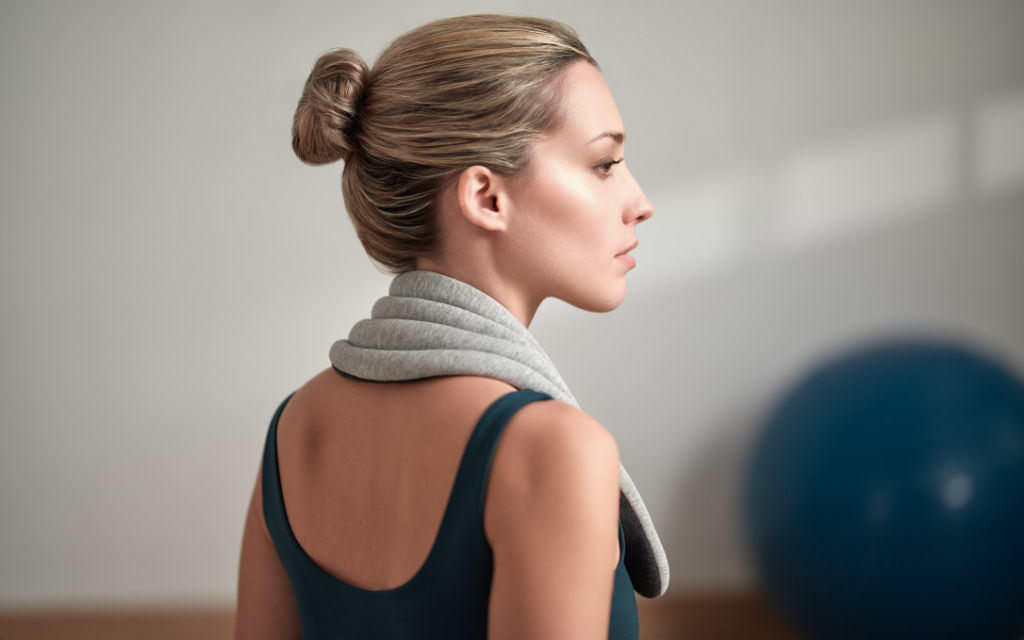 Woman wearing Heated Neck Wrap by Ostrichpillow