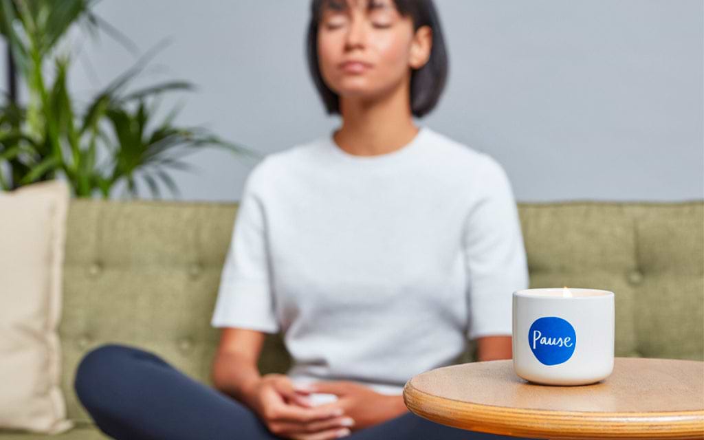 Girl meditating with candle