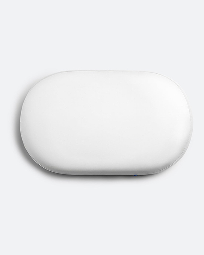Overhead product shot of the contoured Ostrichpillow memory foam Bed Pillow in Powder White, showing its unique supportive shape.