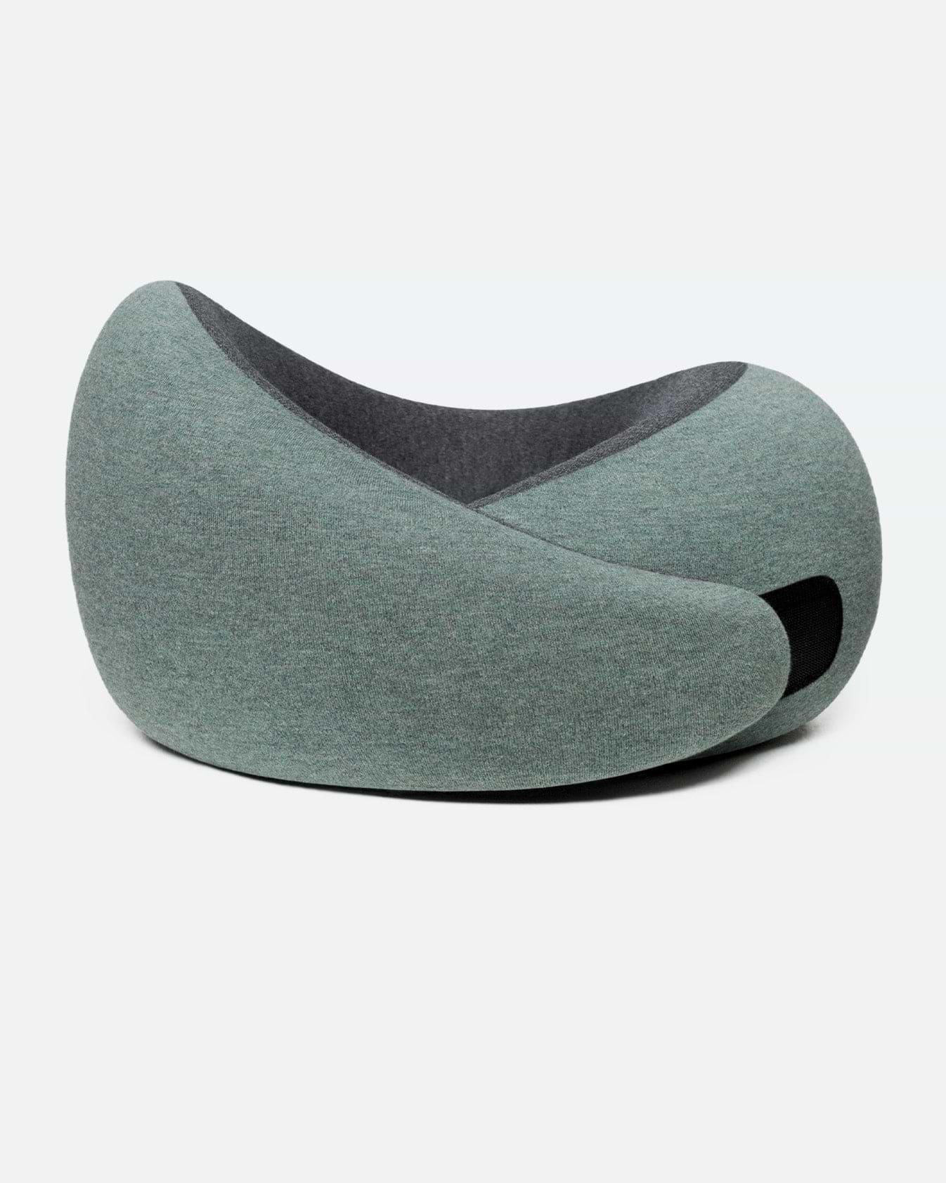 The Go Neck Pillow in the color Green Moss, which has a sage green outer fabric and a charcoal grey inner lining, fastened by its adjustable strip.