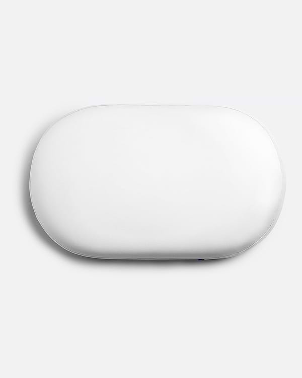 Overhead product shot of the contoured Ostrichpillow memory foam Bed Pillow in Powder White, showing its unique supportive shape.