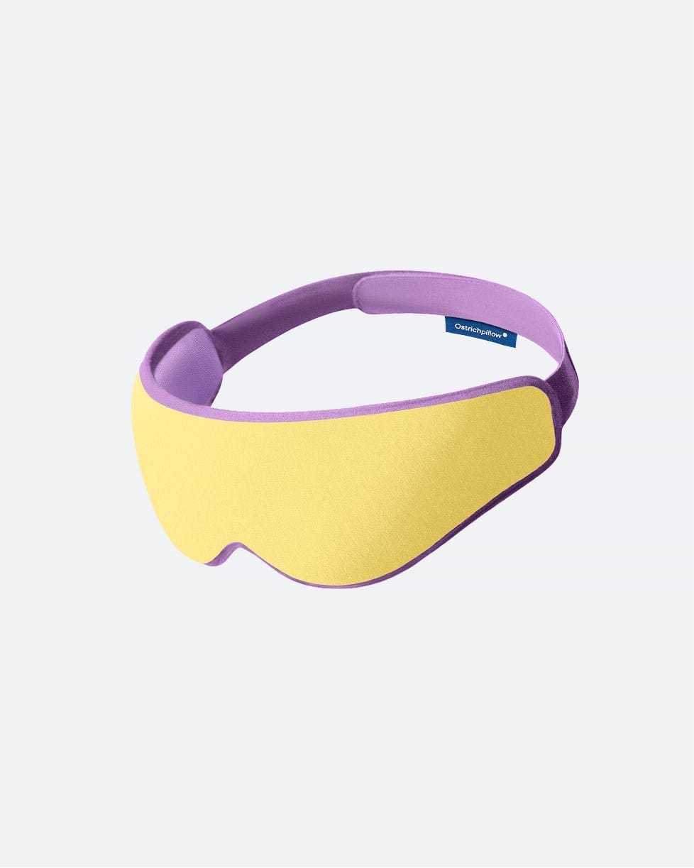 The Eye Mask in the color Daydream. The ergonomic sleep mask features a pastel yellow front panel framed by a lavender border.