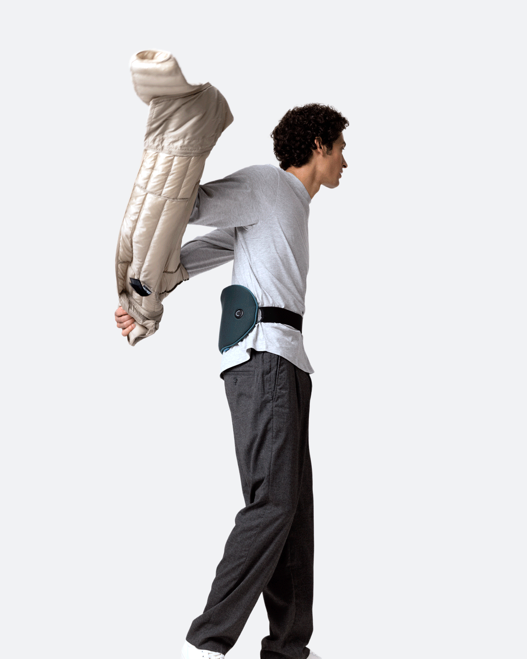 A man on the move wearing Embrace Heating Pad. The device is secured around his lower back, highlighting its wearable design.