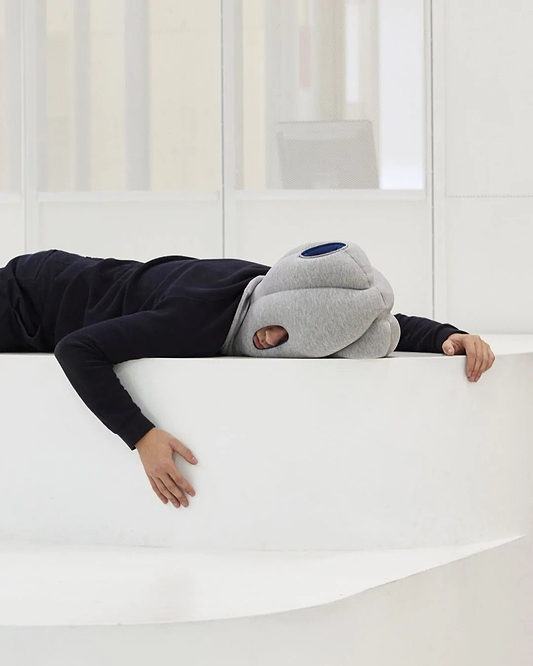 Someone is seen napping face down while horizontally over a ledge, emphasizing the product's ability to provide a comfortable power nap anywhere.