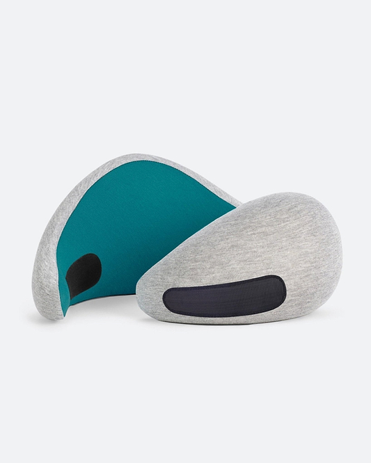 The Go Neck Pillow in the color Blue Reef, an ergonomic travel pillow that features a light grey outer fabric with a deep teal inner lining.