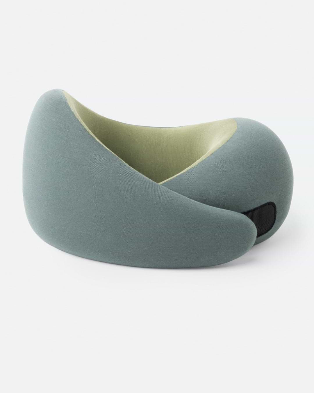 The Go Neck Pillow in the color Forest Snooze, which features a sage outer fabric and an olive green inner lining, fastened by its adjustable strip.
