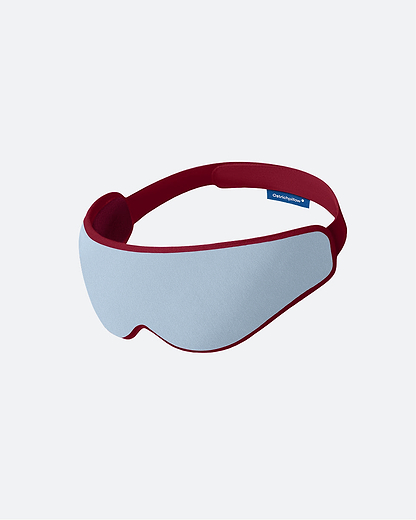 The Eye Mask in the color Dawn. The ergonomic sleep mask features a soft, light sky blue front panel framed by a burgundy wine-red border.