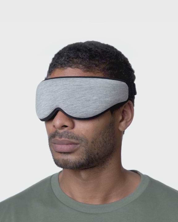 Midnight Grey Eye Mask highlighting its blink-friendly eye cups, nose bridge, 6 layers for total blackout, no-snag strap, and an adaptable fit.