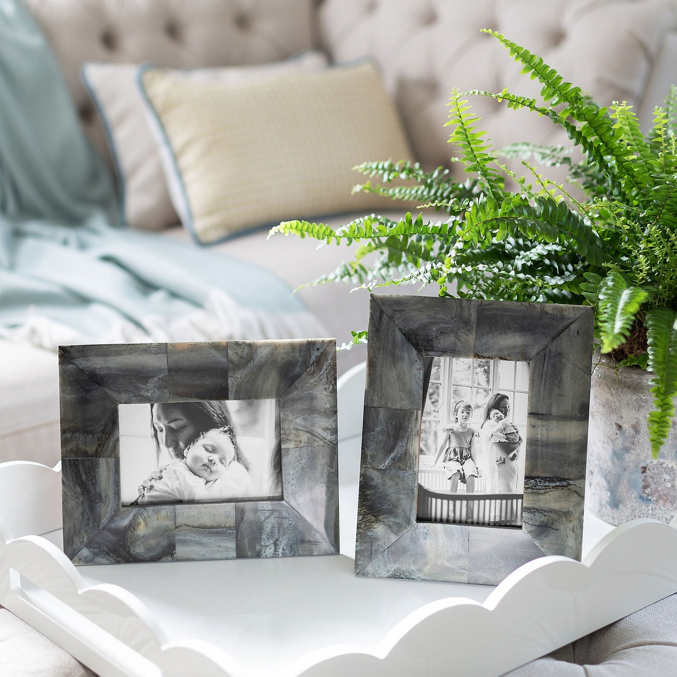 Photo frames on a large white lacquer tray