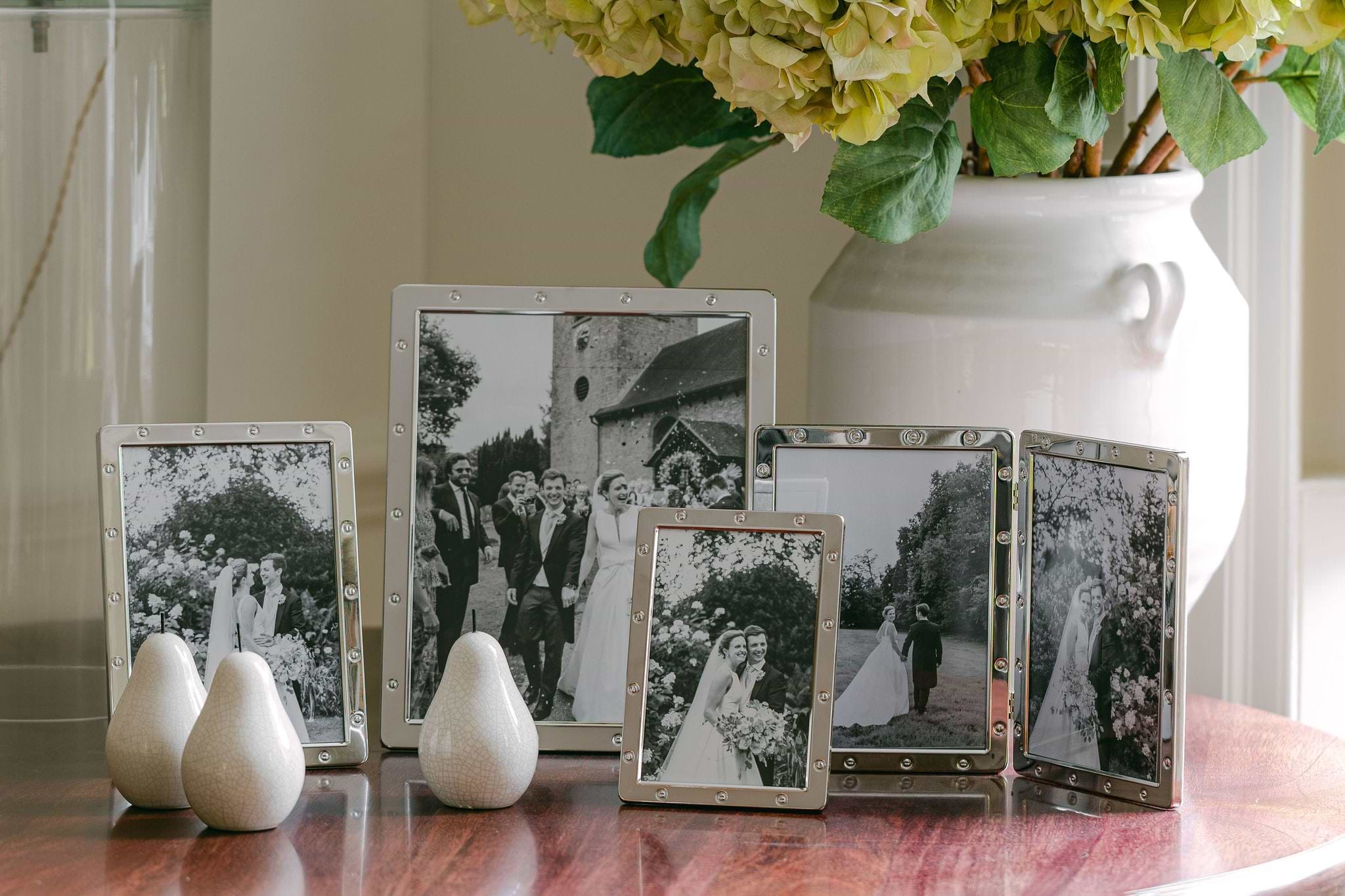 8 silver plated picture frames featuring black and white family photos