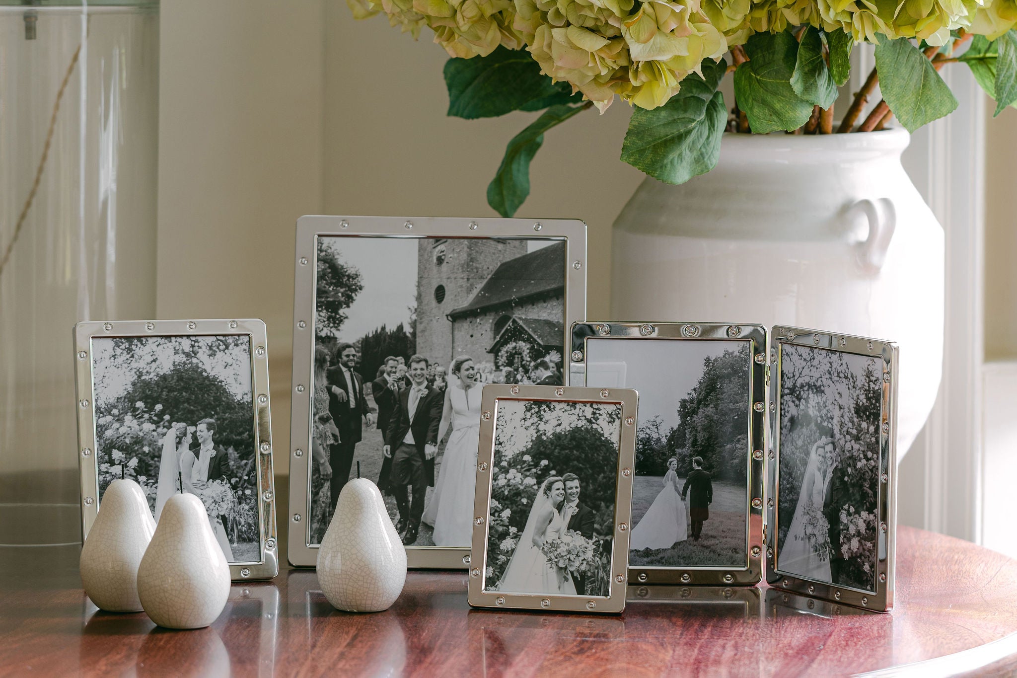 8 silver plated picture frames featuring black and white family photos