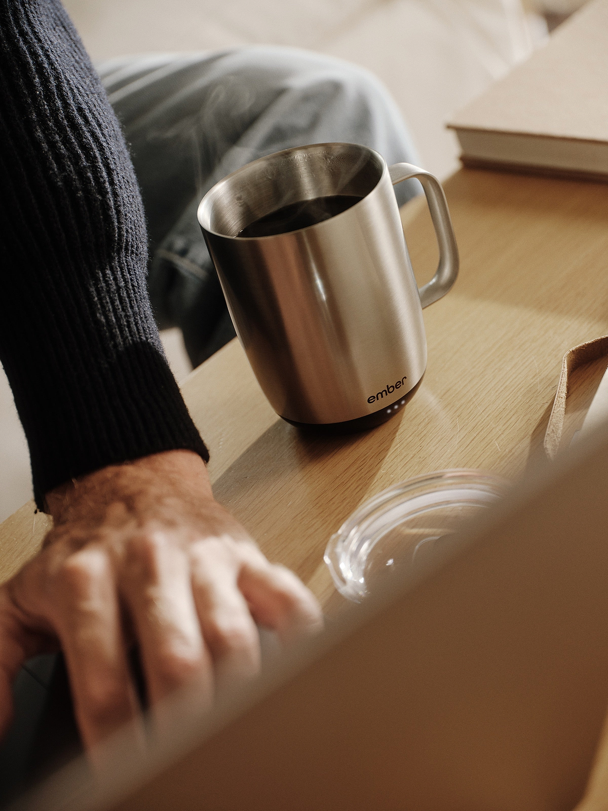 Stainless steel Ember Mug 3 beside a laptop during the workday