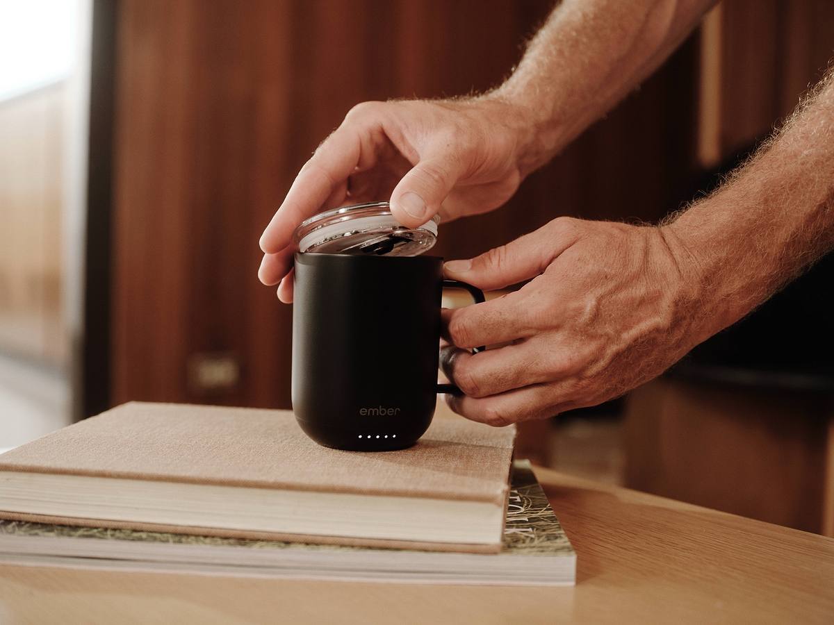 Placing the included sliding lid on a black Ember Mug 3