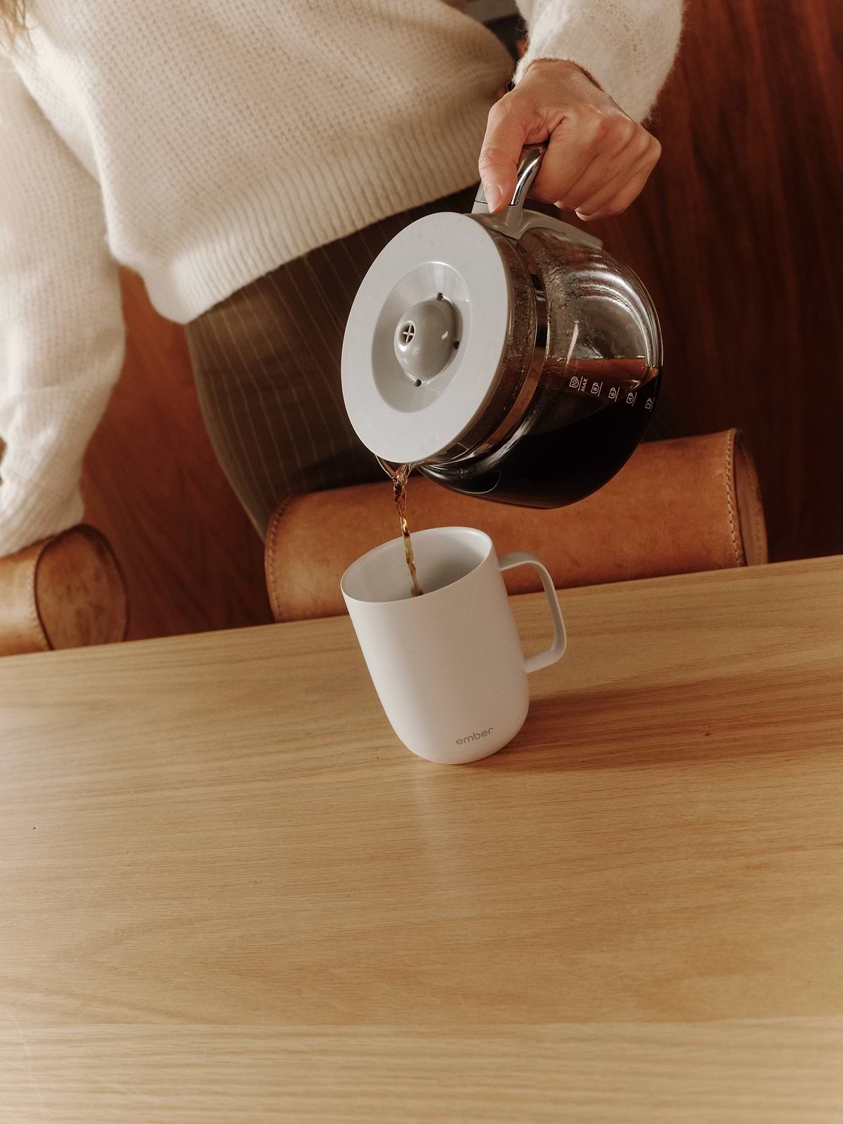 Pouring freshly brewed coffee into a white Ember Mug 3