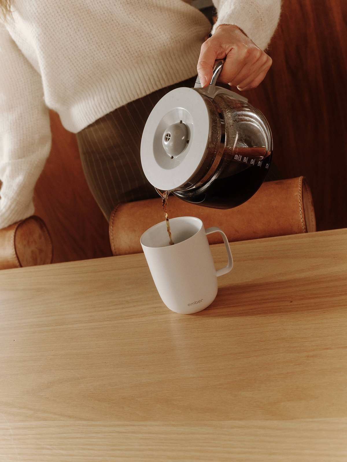 Pouring freshly brewed coffee into a white Ember Mug 3