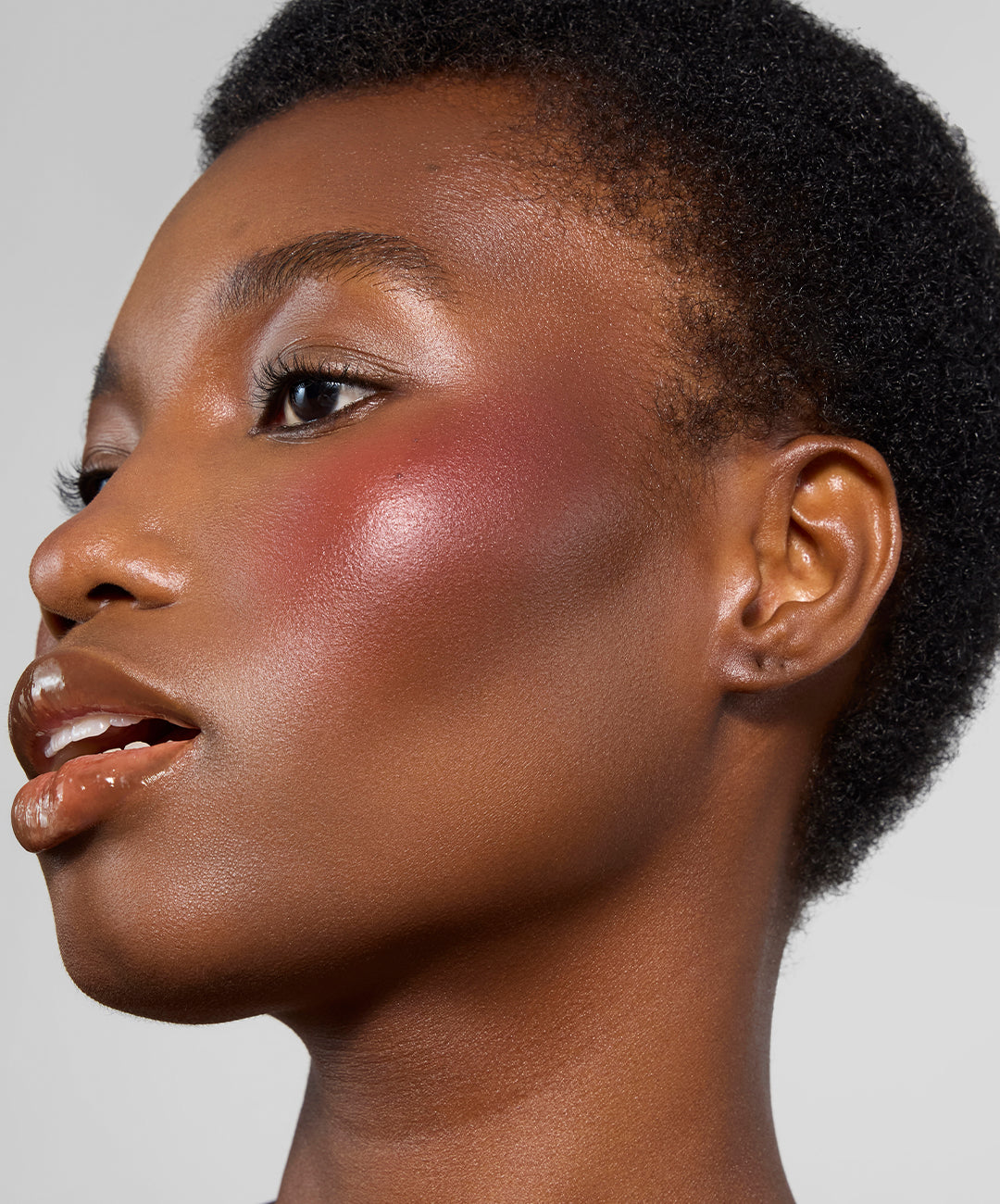 | desc: Elisabeth wears Sepia Lip Gloss, <br> Cedar Cream Bronzer & Plum Cream Blush