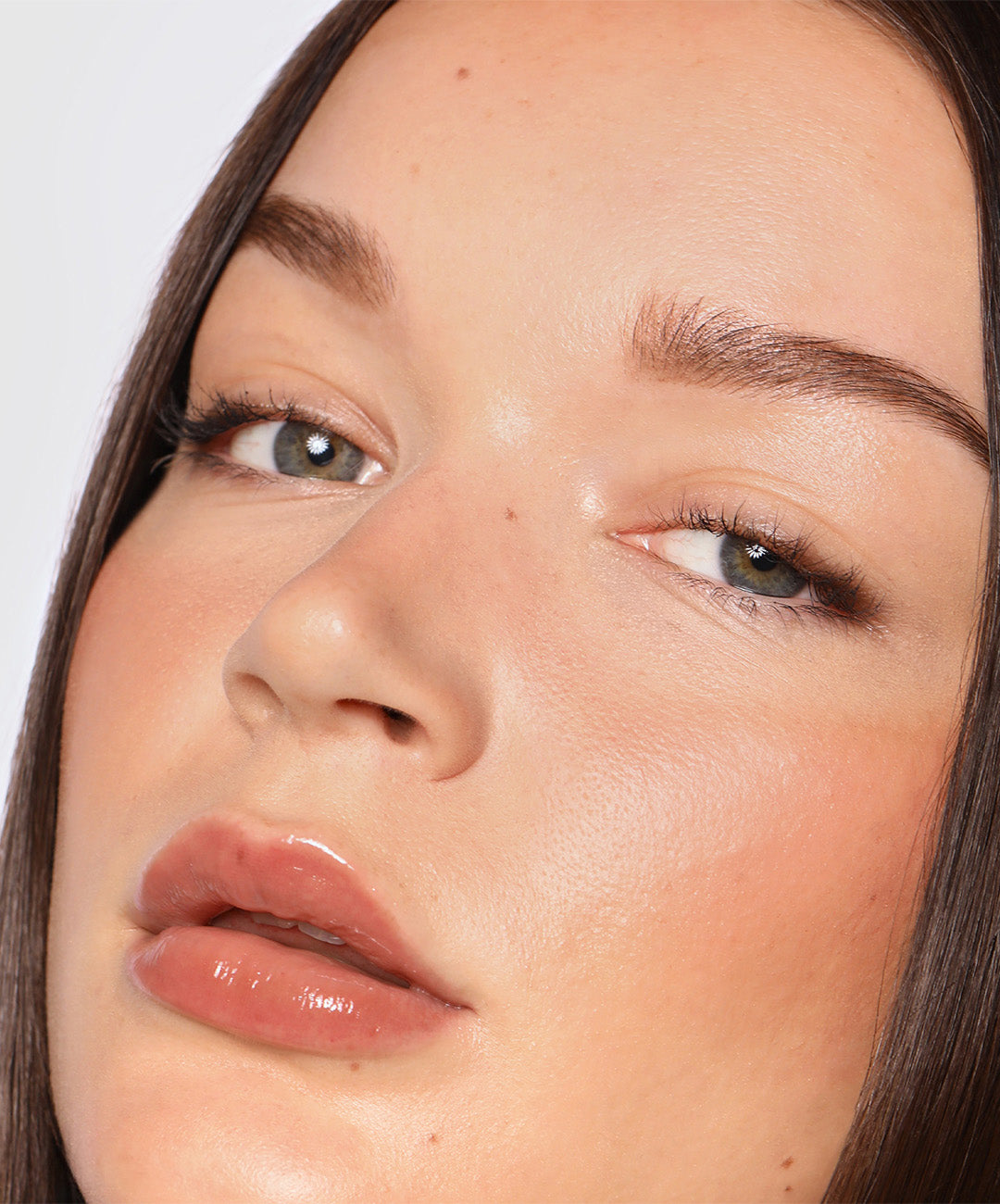 Ellie wears Lip Gloss in shade Taupe