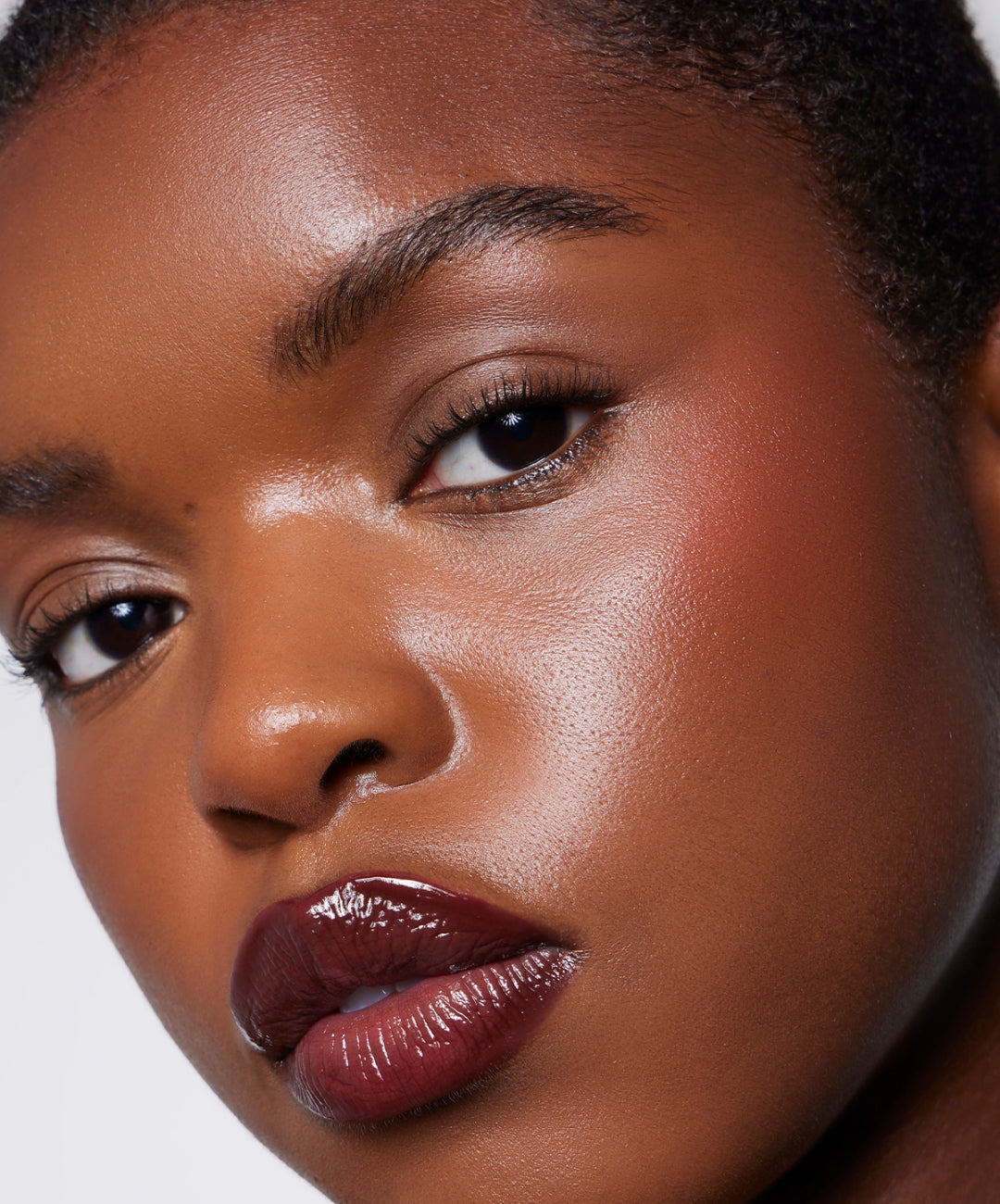 Model wears Lip Gloss in Plum