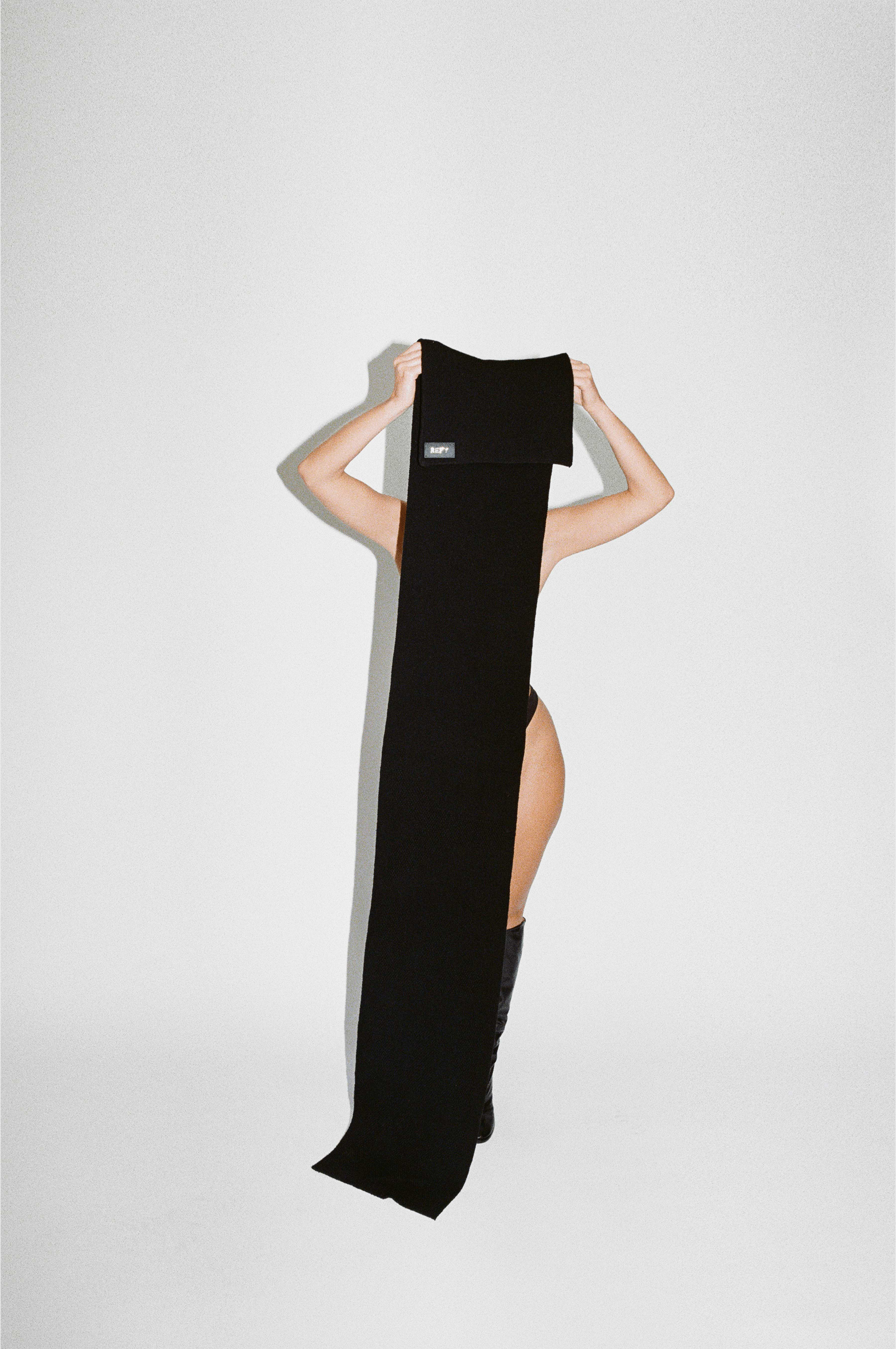 FRONT IMAGE OF REFY WOOL SCARF IN BLACK WITH MODEL
