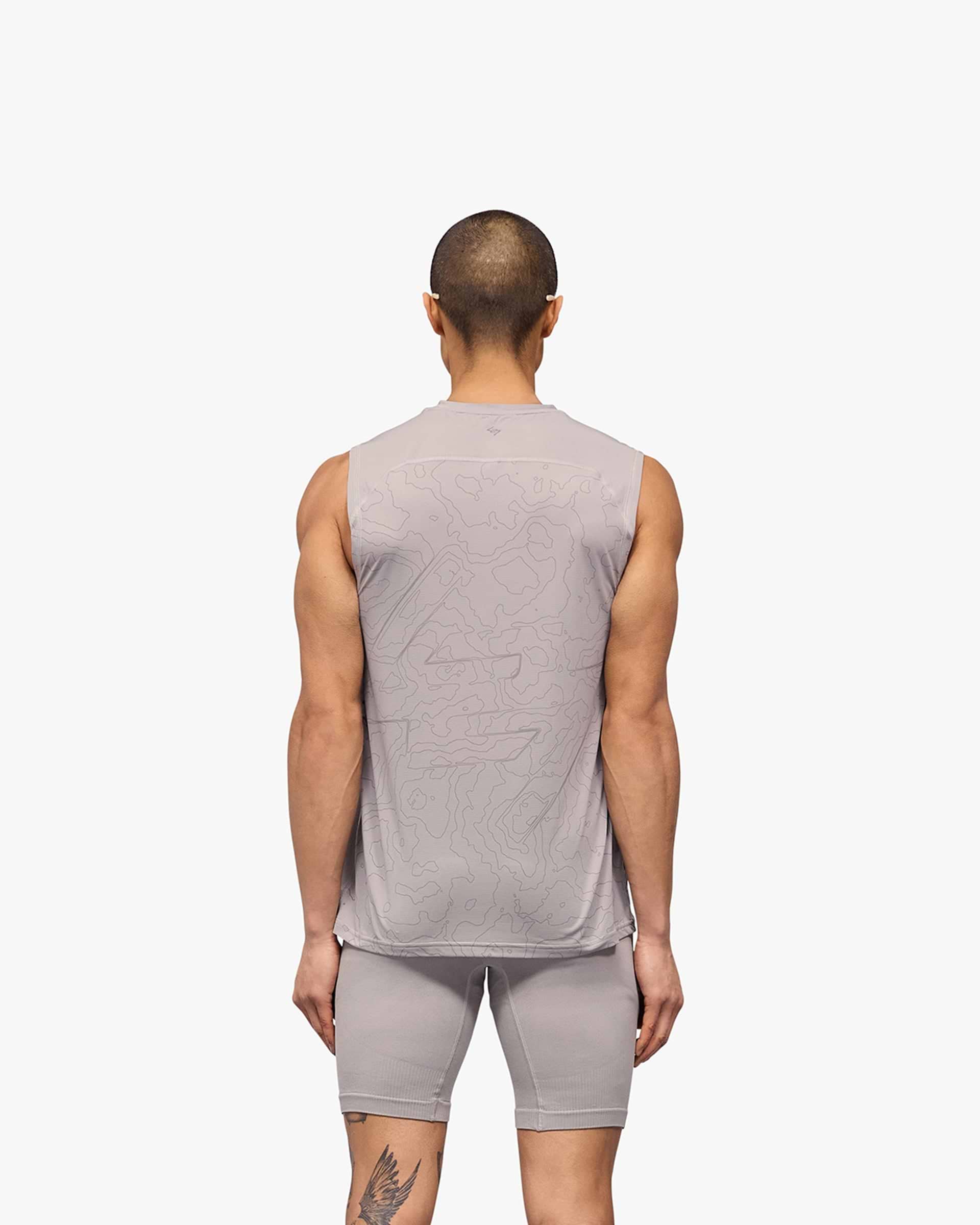 Man wearing a grey running tank on a plain white background | 247 Contour Run Tank in Titanium | Breathable sweat-wicking running tank | 247 T-Shirts | Represent Clo