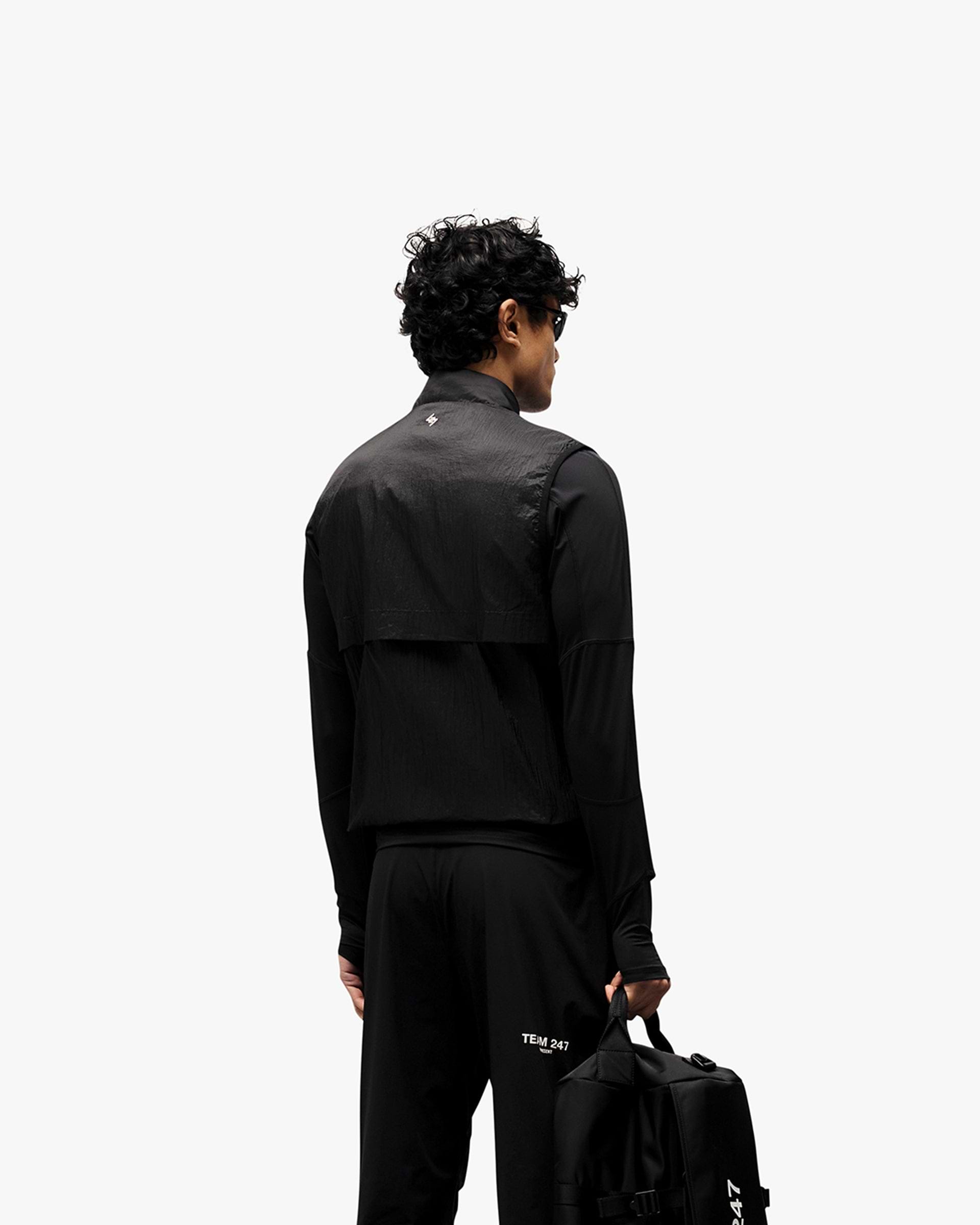 Man wearing a black gilet on a plain white background | 247 Run Gilet in Black | Gilet with insulation and windproof front | 247 Outerwear | Represent Clo