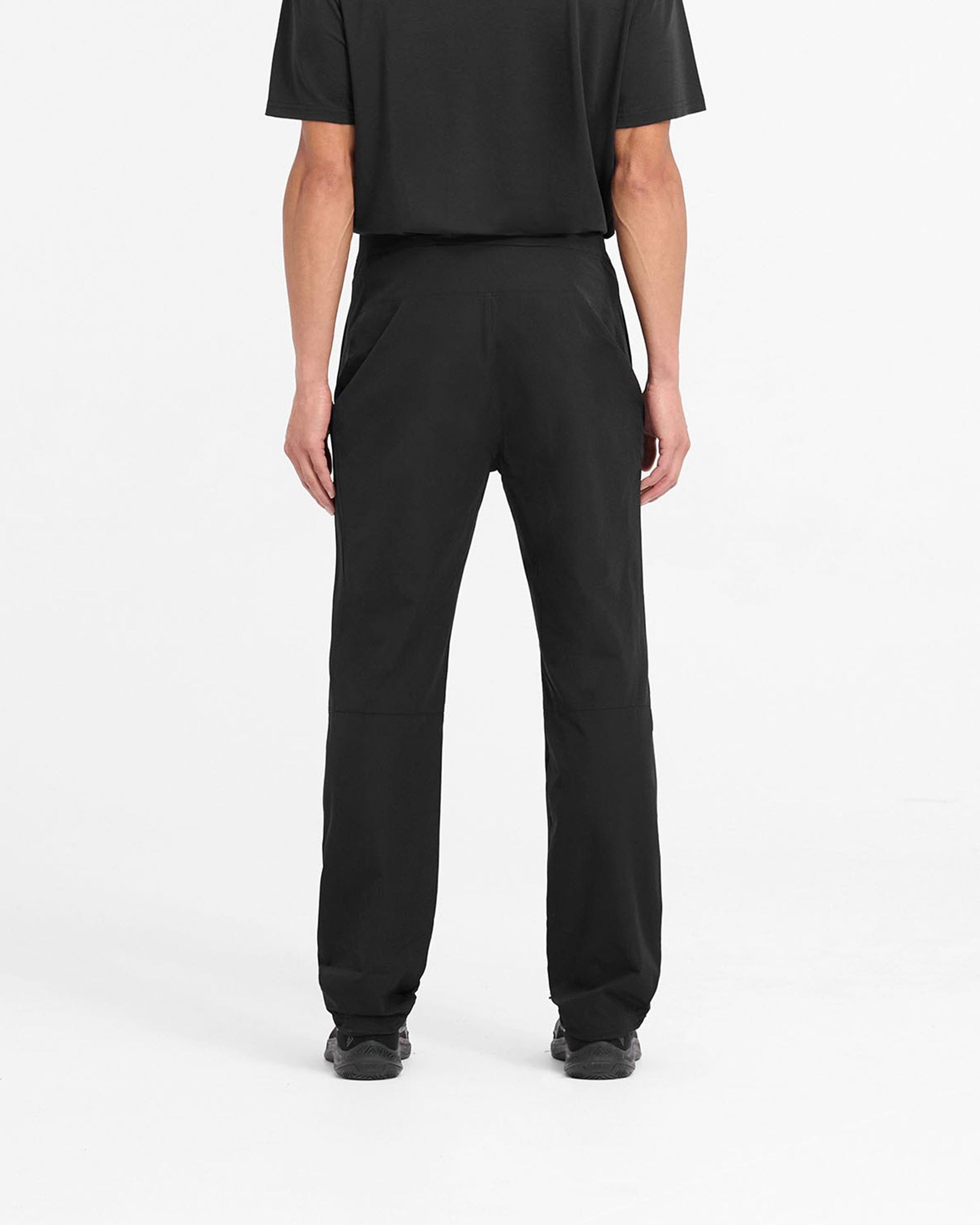 Man wearing black pants on a plain white background | 247 Mission Pant in Black | Straight leg pants with zip pockets and built-in belt | 247 Pants | Represent Clo