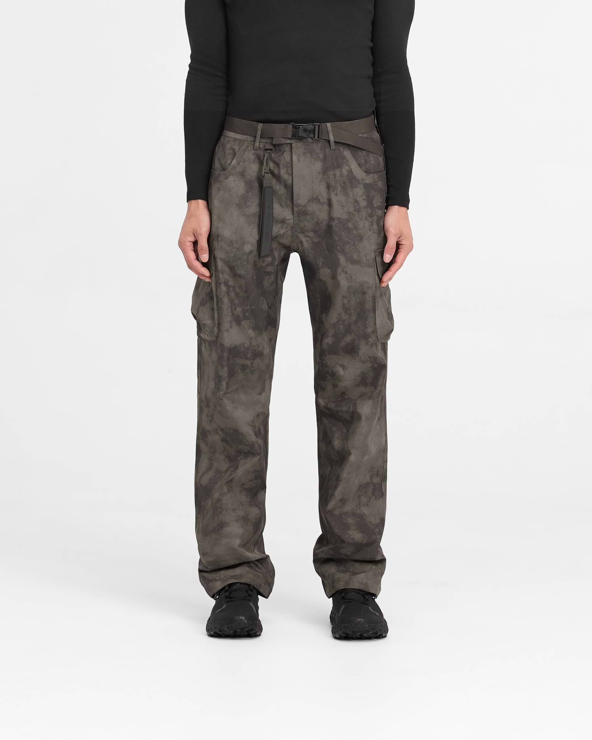 Man wearing straight leg green cargo pants on a plain white background | 247 Technical Cargo Pant in Terrain | Waterproof tech cargos with maglock buckle and bungee cord hem | 247 Pants | Represent Clo