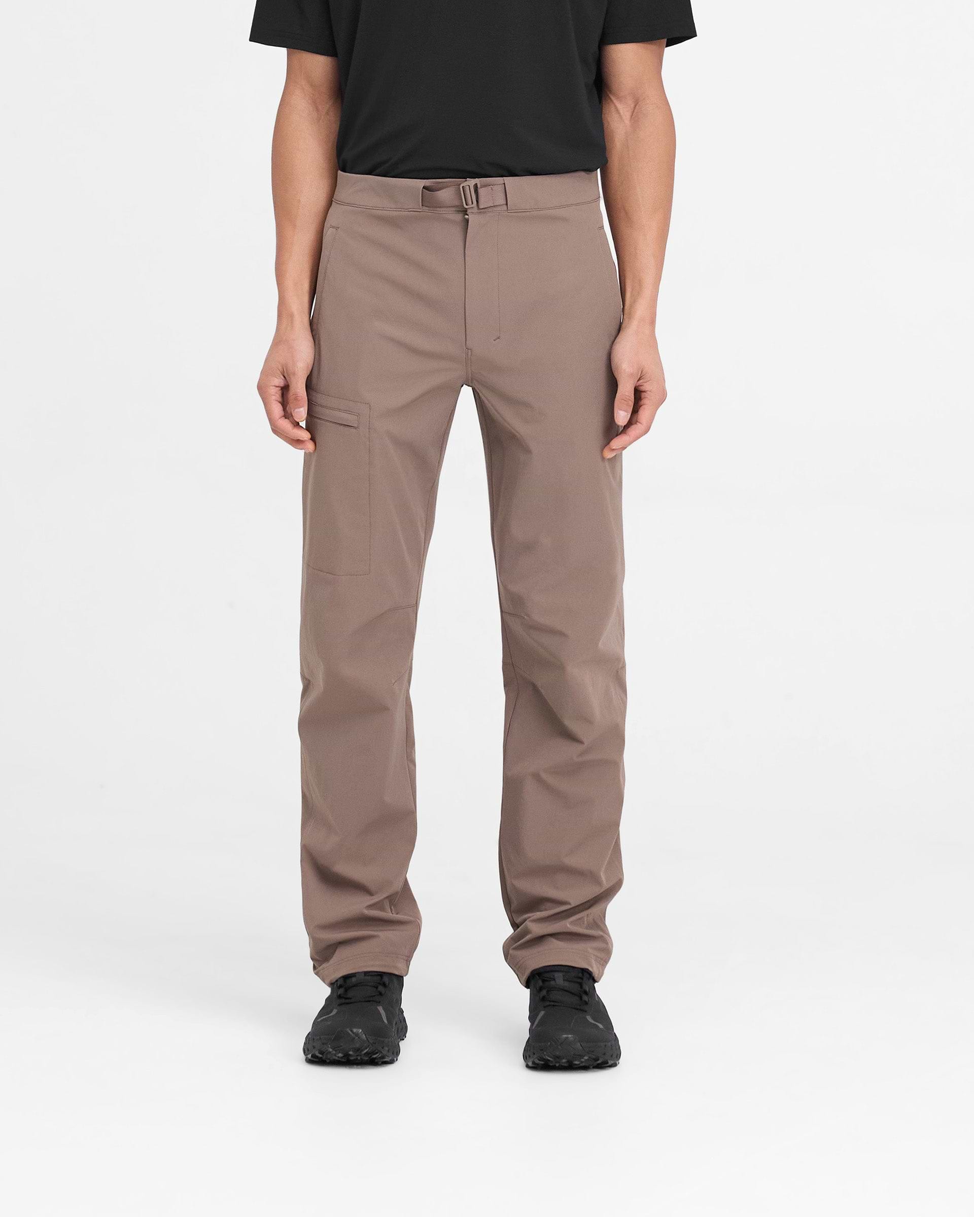 Man wearing mens umber pants on a plain white background | 247 Mission Pant in Umber | Straight leg nylon pants with zip pockets and built-in belt | 247 Pants | Represent Clo