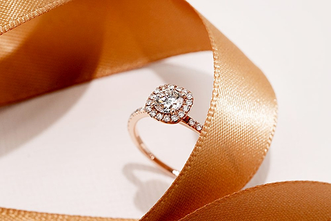 proposing at home by using a ribbon to lead to the surprise engagement ring