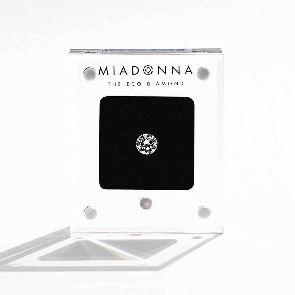 MiaDonna lab-grown diamond in a hand-held transparent display box.