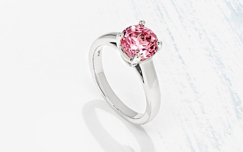 affordably priced solitaire engagement ring with lab created pink sapphire center stone