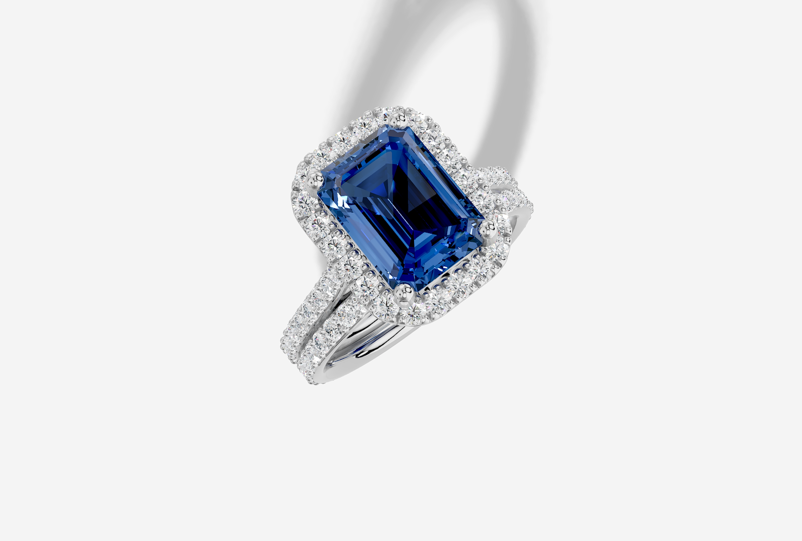 10.5 x 8.0 mm Emerald Cut Lab Grown Sapphire Shared Prong Cathedral Halo Engagement Ring in 18K Gold and 0.36 ctw Matching Band
