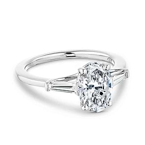 Beautiful three stone engagement ring with trellis set 2ct oval cut lab grown diamond amid baguette side stones in 14k white gold
