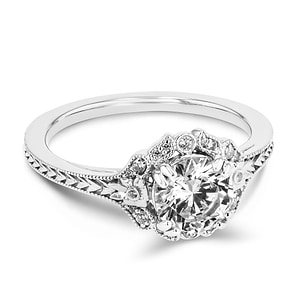 diamond halo engagement ring with chevron detailed band set with a round cut lab grown diamond center stone in 14k white gold recycled metal