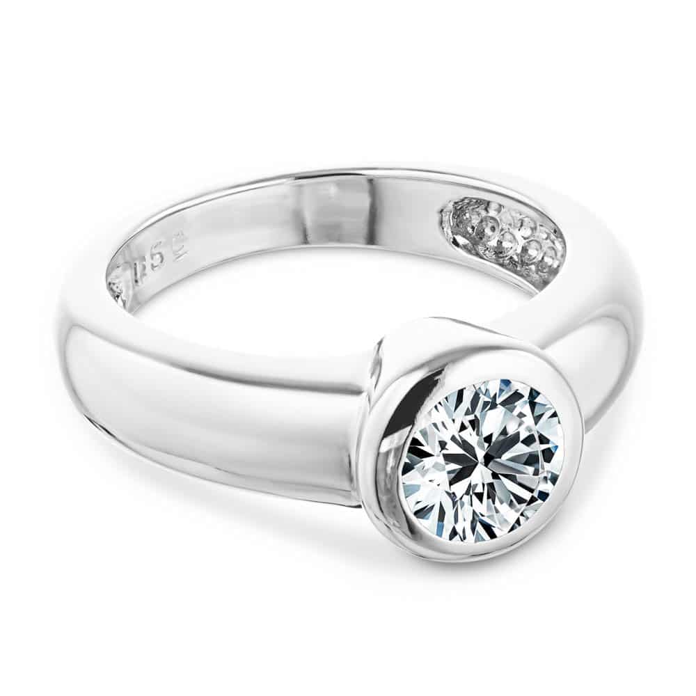Shown with 1ct Round Cut Lab Grown Diamond in 14k White Gold|Modern minimalistic bezel solitaire engagement ring with 1ct round cut lab grown diamond in thick 14k white gold band